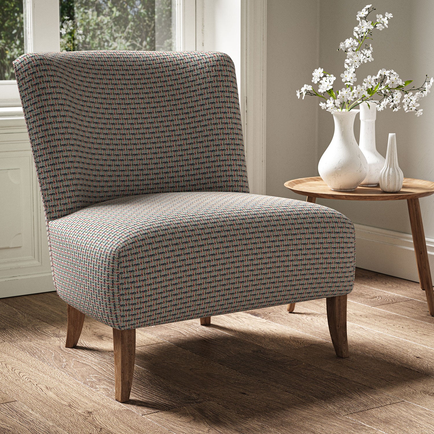Armchair in a printed linen fabric with textural weave pattern in blue and red colours.