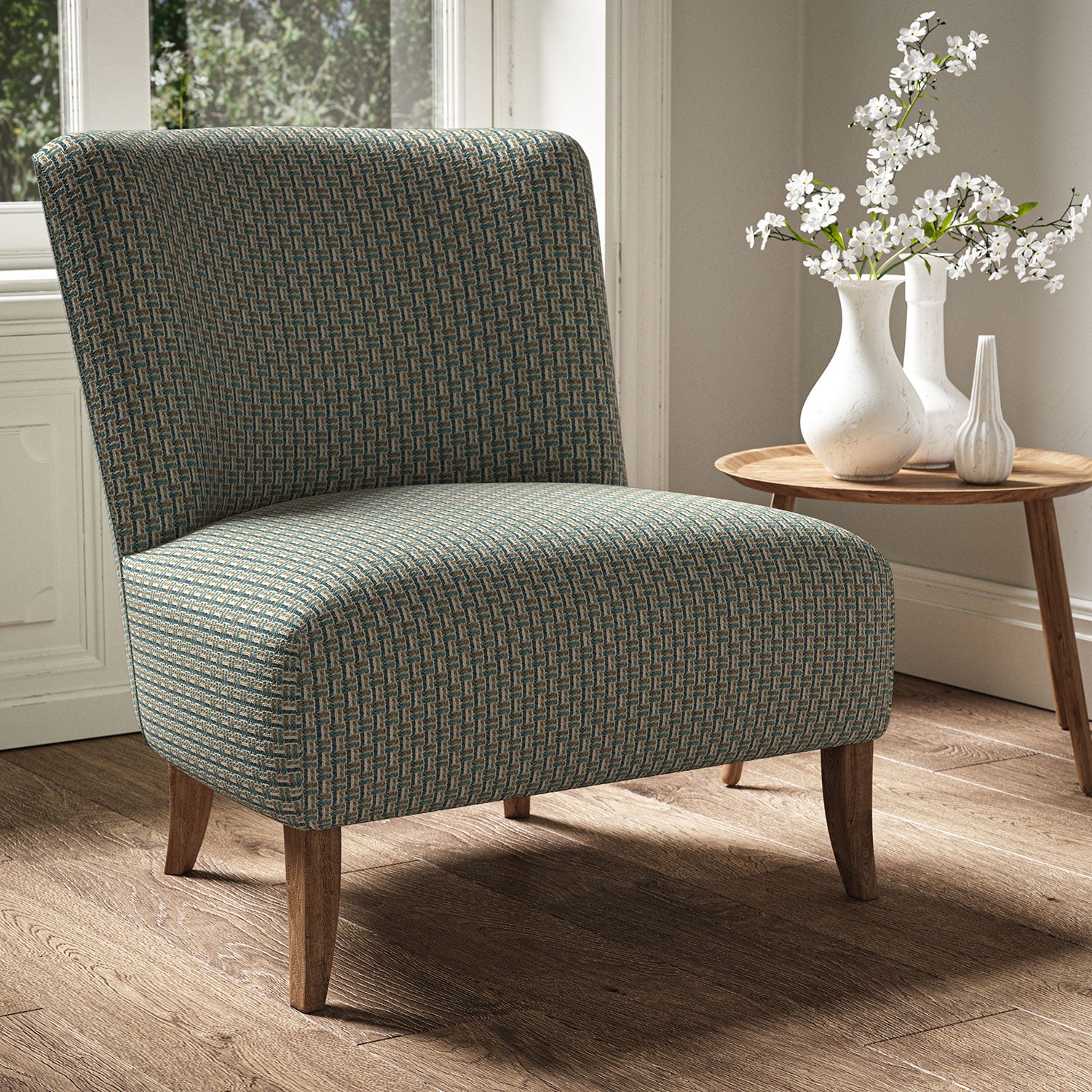 Armchair in a printed linen fabric with textural weave pattern in brown and blue colours.