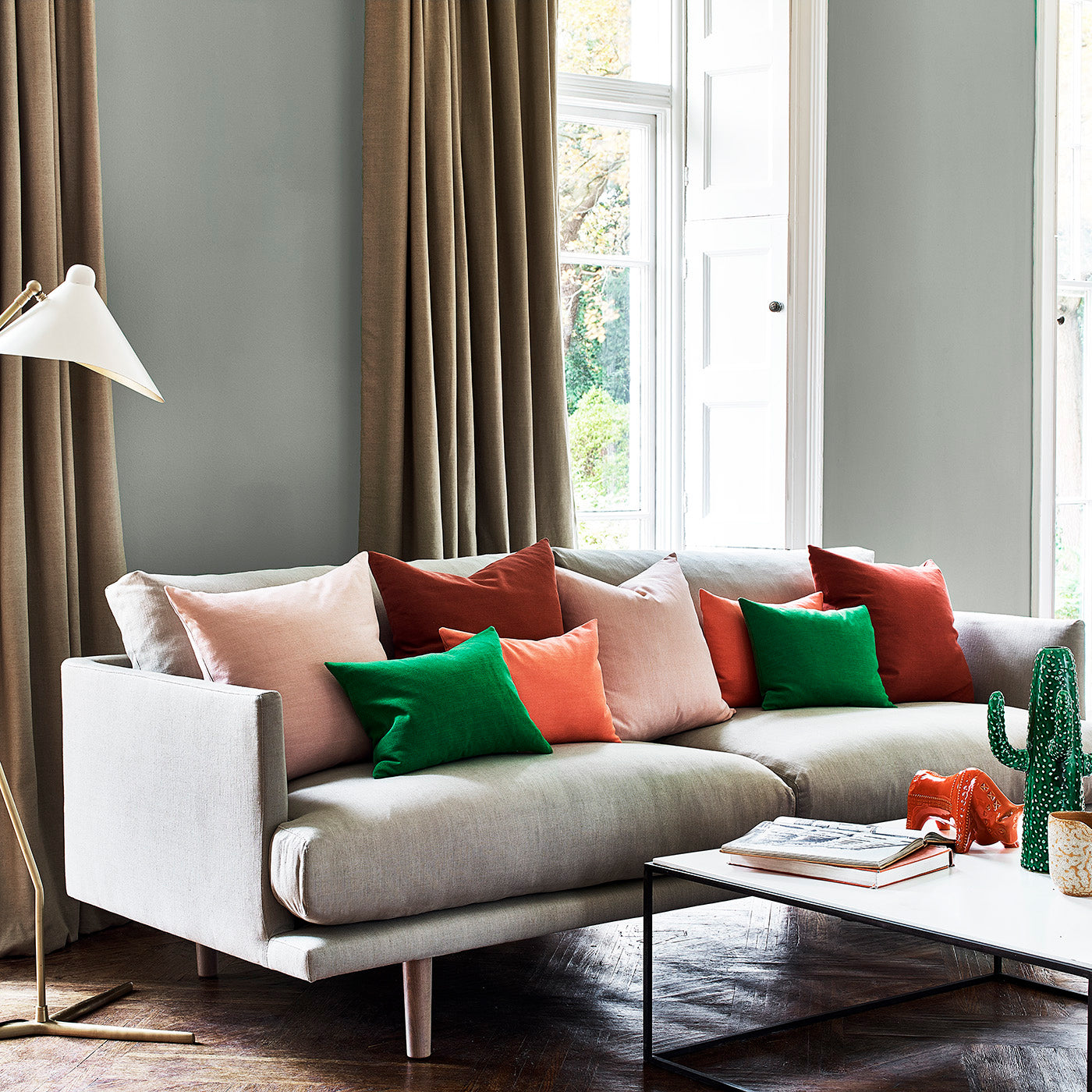 Grey sofa & colourful cushions in Juno - a plain fabric.