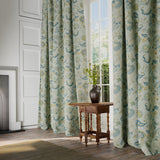 Curtains in a printed linen fabric with tree of life design in blue and green colours.