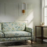 Sofa in a printed linen fabric with tree of life design in blue and green colours.
