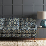 Velvet sofa upholstered in a printed velvet fabric with an oriental geometric design in blue colours