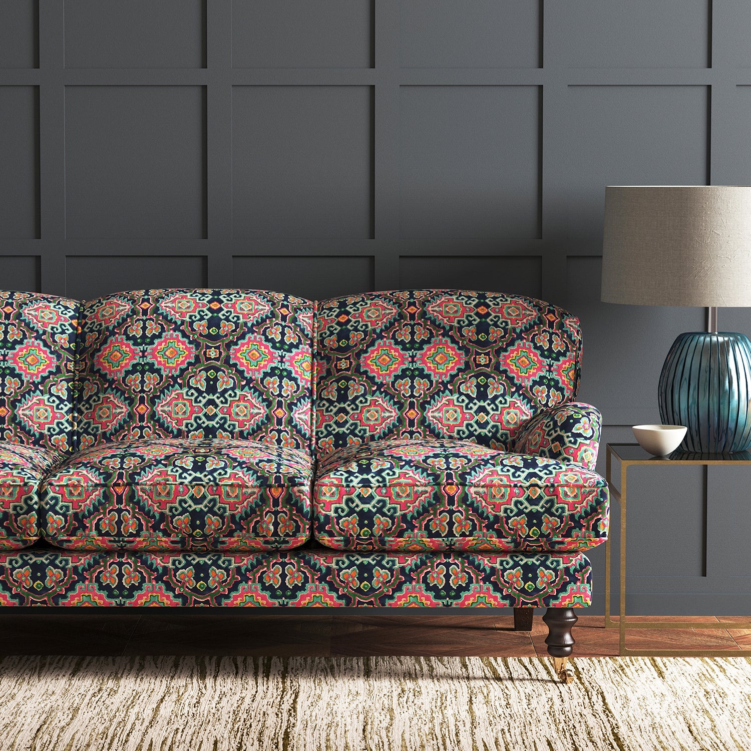 Velvet sofa upholstered in a printed velvet fabric with an oriental geometric design in vibrant colours