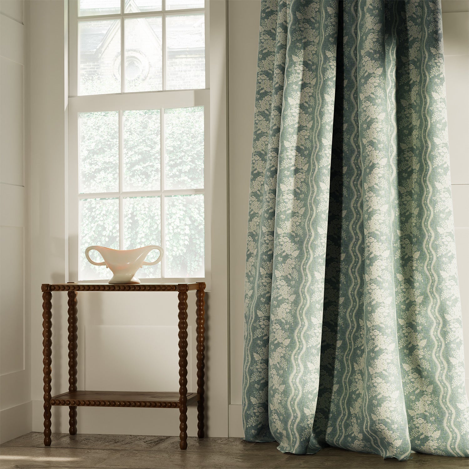 Curtains in a classic duck egg coloured floral fabric with stripe design