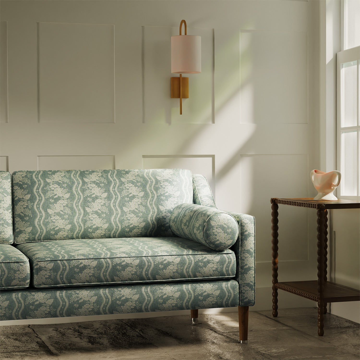 Sofa upholstered in a duck egg coloured floral fabric with stripe design