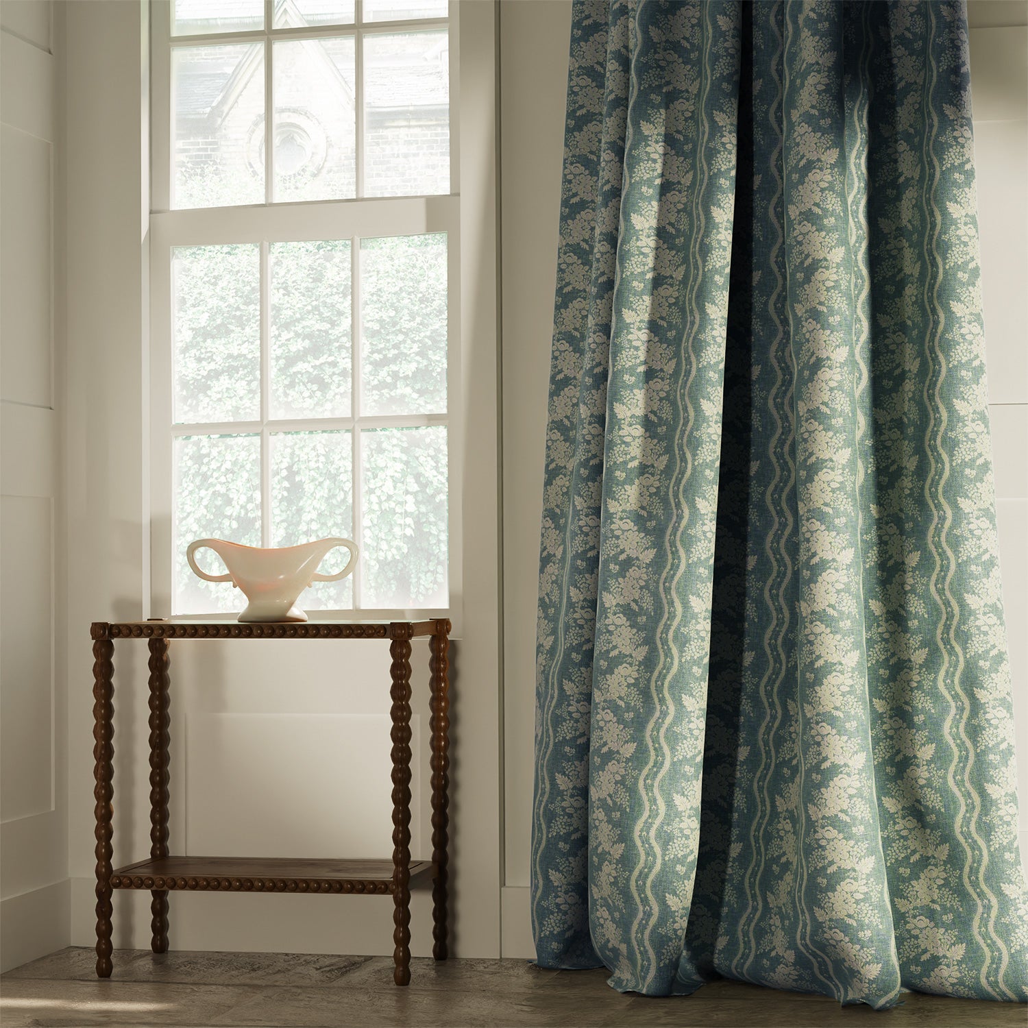 Curtains upholstered in a blue floral fabric with striped design for curtains and upholstery
