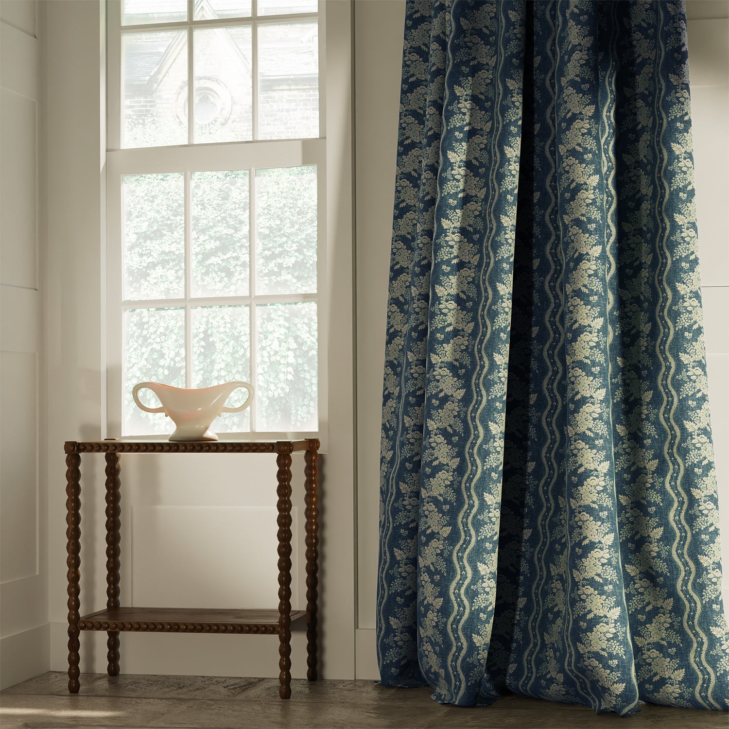 Curtains in a classic navy floral fabric with stripe design