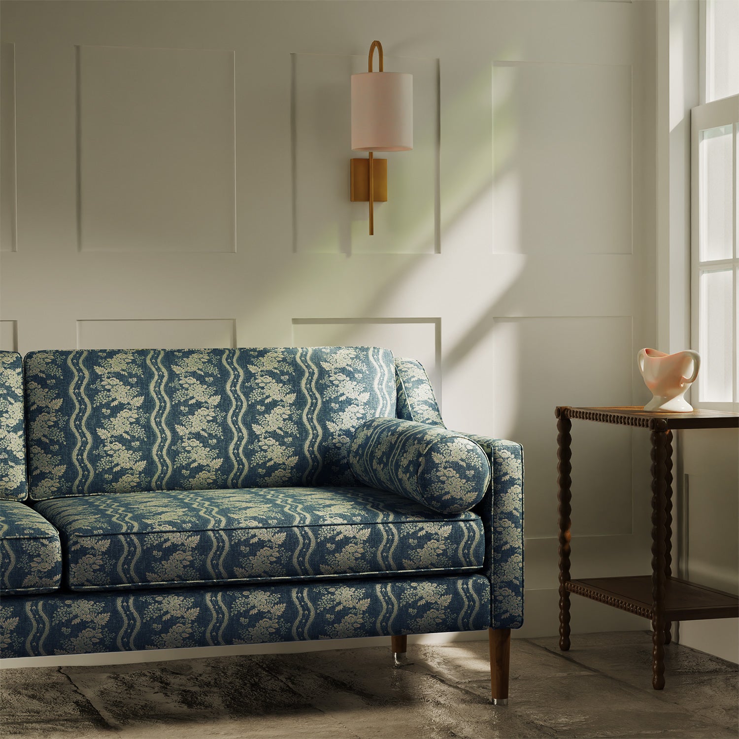 Sofa upholstered in a navy floral fabric with stripe design