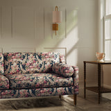 Sofa upholstered in a luxury dark blue and pink floral bouquet fabric