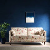 Sofa with a white fabric with pink and blue stylised floral design