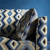 Sofa upholstered in a blue and neutral upholstery fabric with geometric Navajo inspired design
