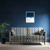 Sofa upholstered in a blue and neutral upholstery fabric with geometric Navajo inspired design