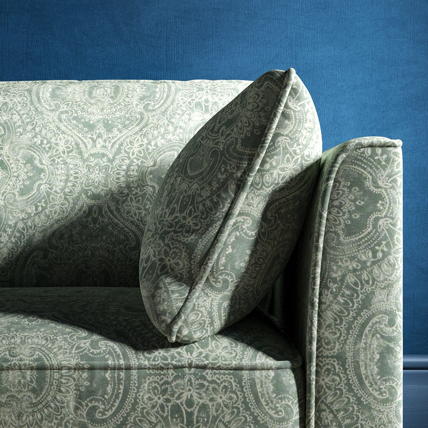Sofa upholstered in a smokey blue upholstery fabric with intricate jewel like design