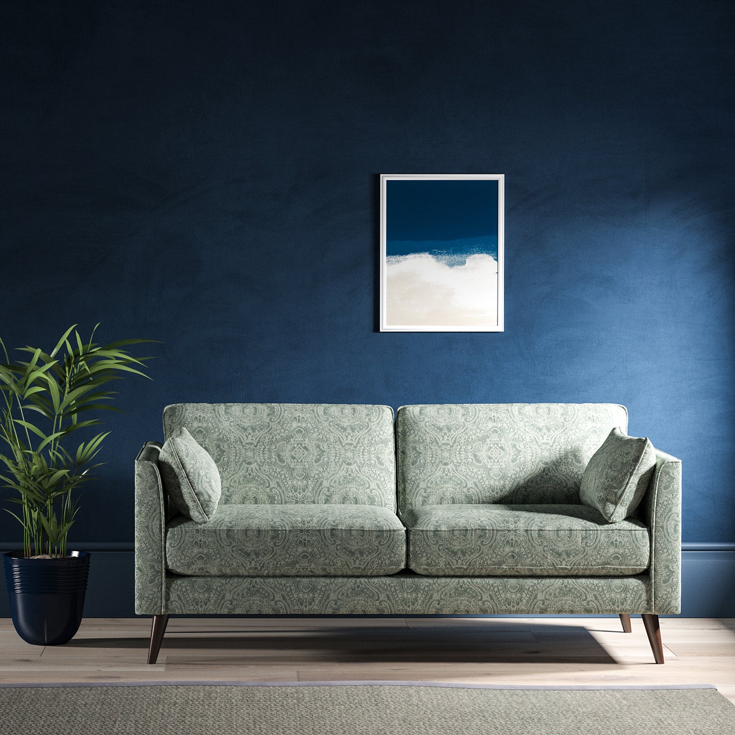 Sofa upholstered in a smokey blue upholstery fabric with intricate jewel like design