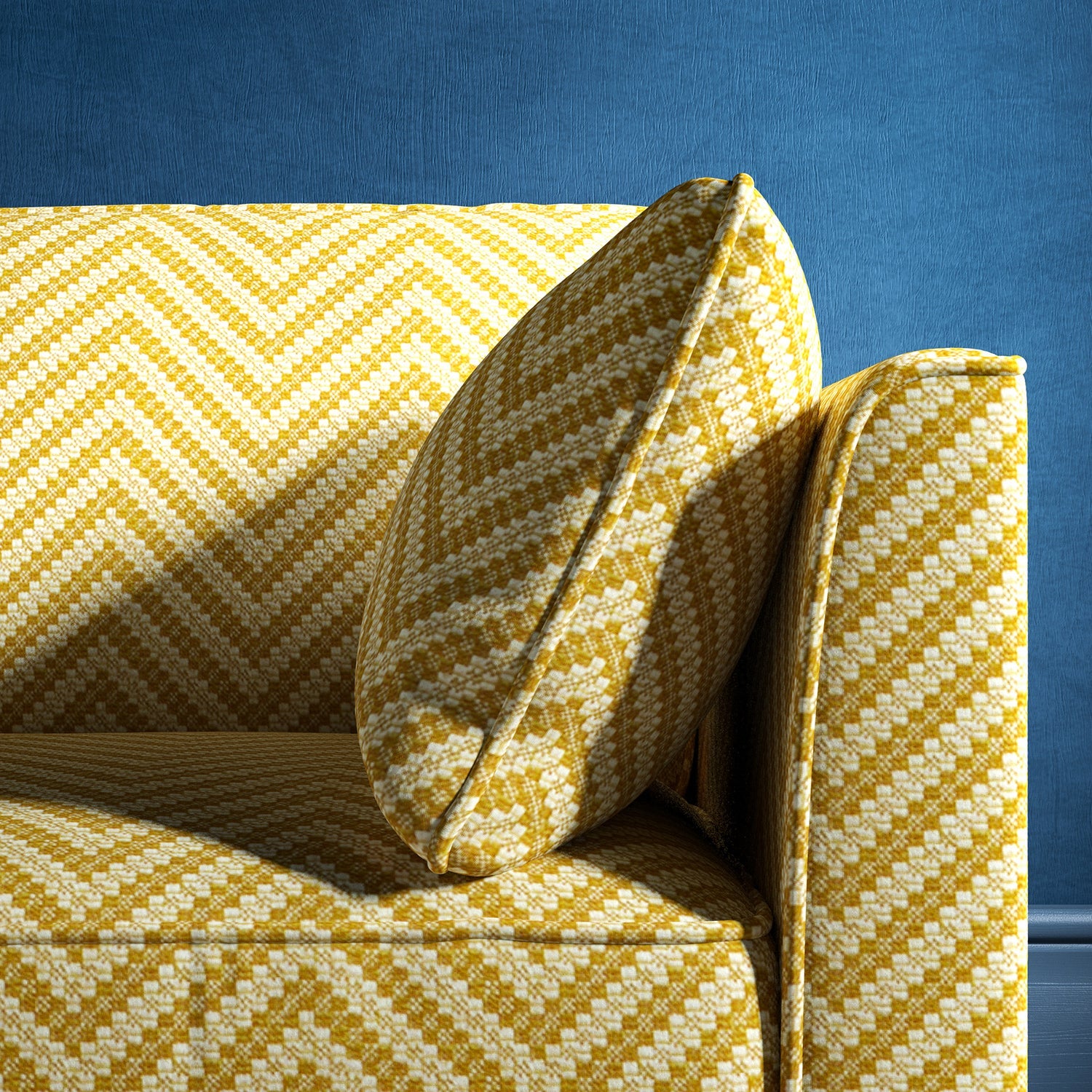 Sofa upholstered in a yellow and neutral herringbone upholstery fabric