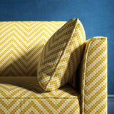 Sofa upholstered in a yellow and neutral herringbone upholstery fabric