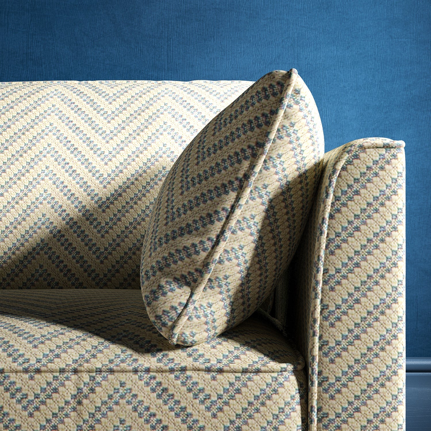 Sofa upholstered in a light blue and neutral herringbone upholstery fabric
