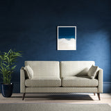 Sofa upholstered in a light blue and neutral herringbone upholstery fabric