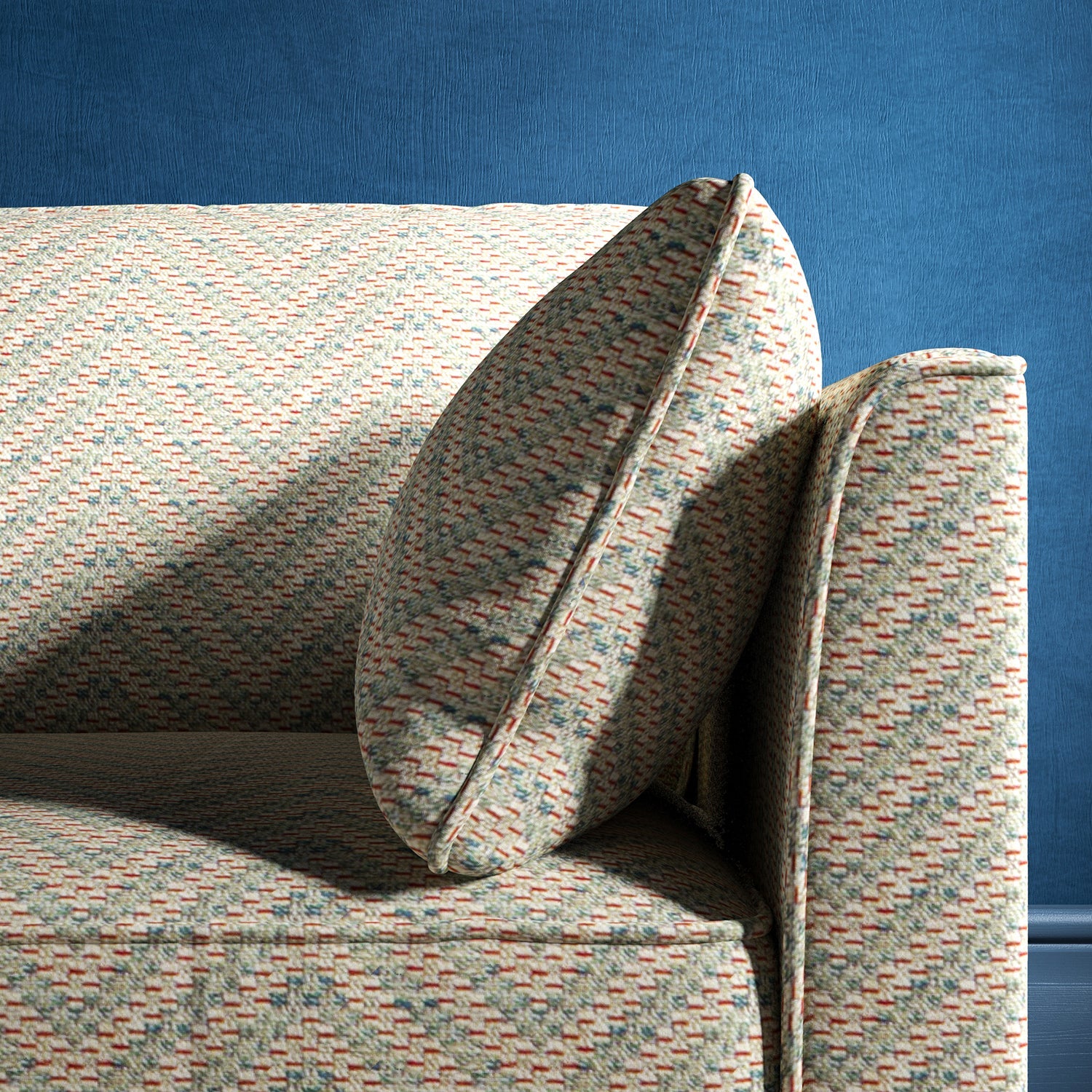 Sofa upholstered in a light blue and neutral herringbone upholstery fabric