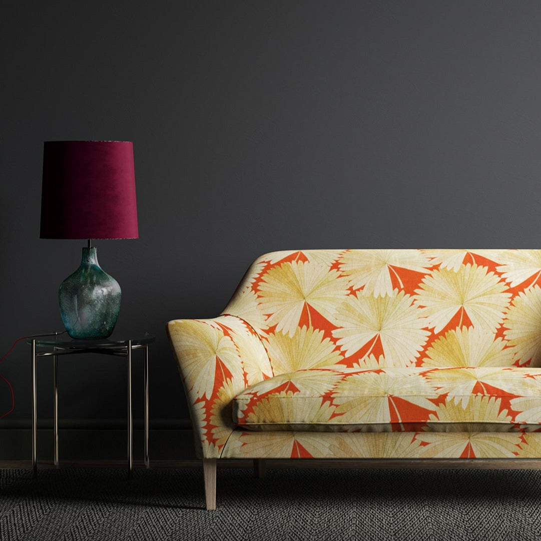Sofa in an orange linen fabric with oriental printed fan design.