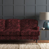Velvet sofa upholstered in a dark red velvet fabric with a carpet design and a stain resistant finish