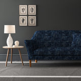 Blue velvet sofa upholstered in a blue velvet fabric with a carpet design and a stain resistant finish