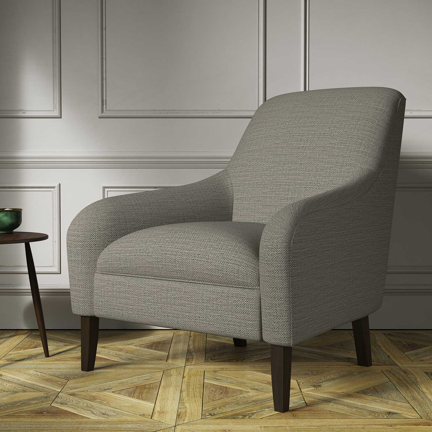 Chair covered in a woven fabric in a herringbone design in Zinc