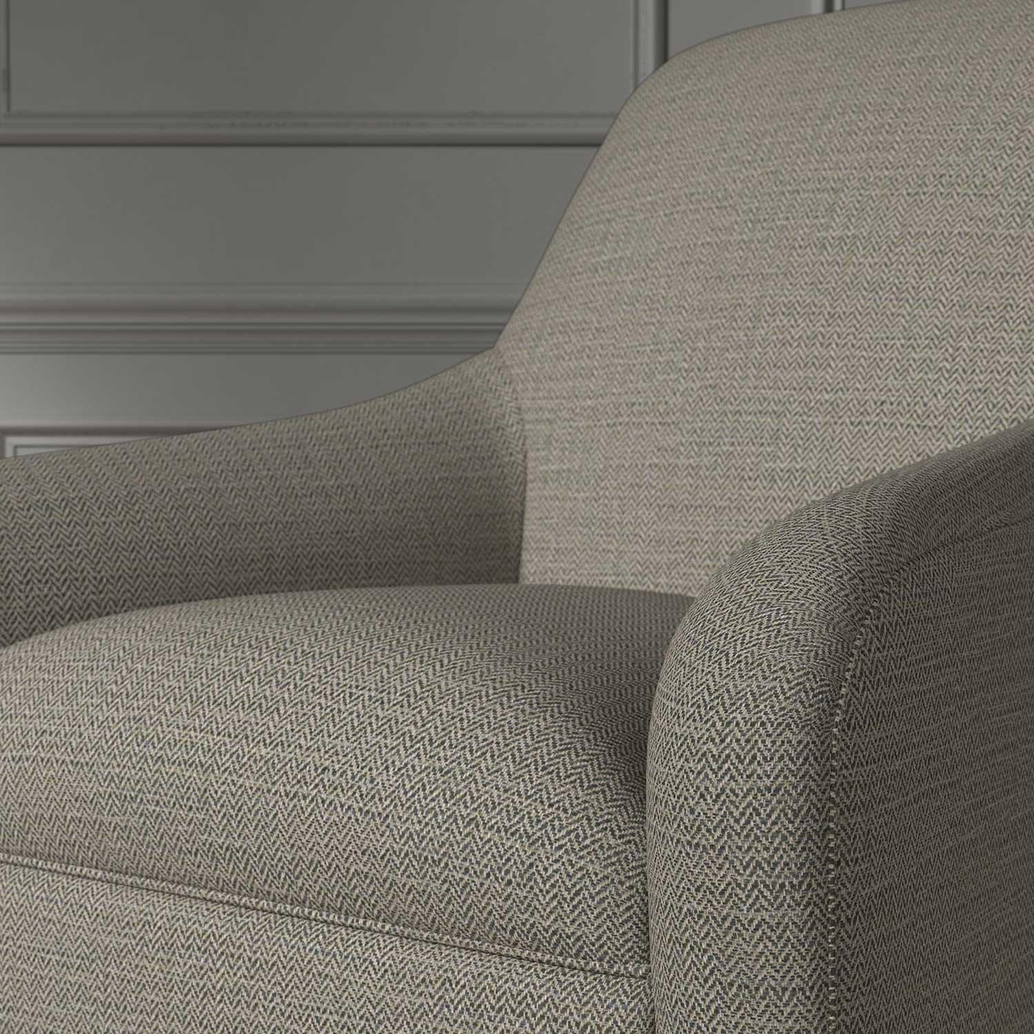 Close up of a chair covered in a woven fabric in a herringbone design in Zinc