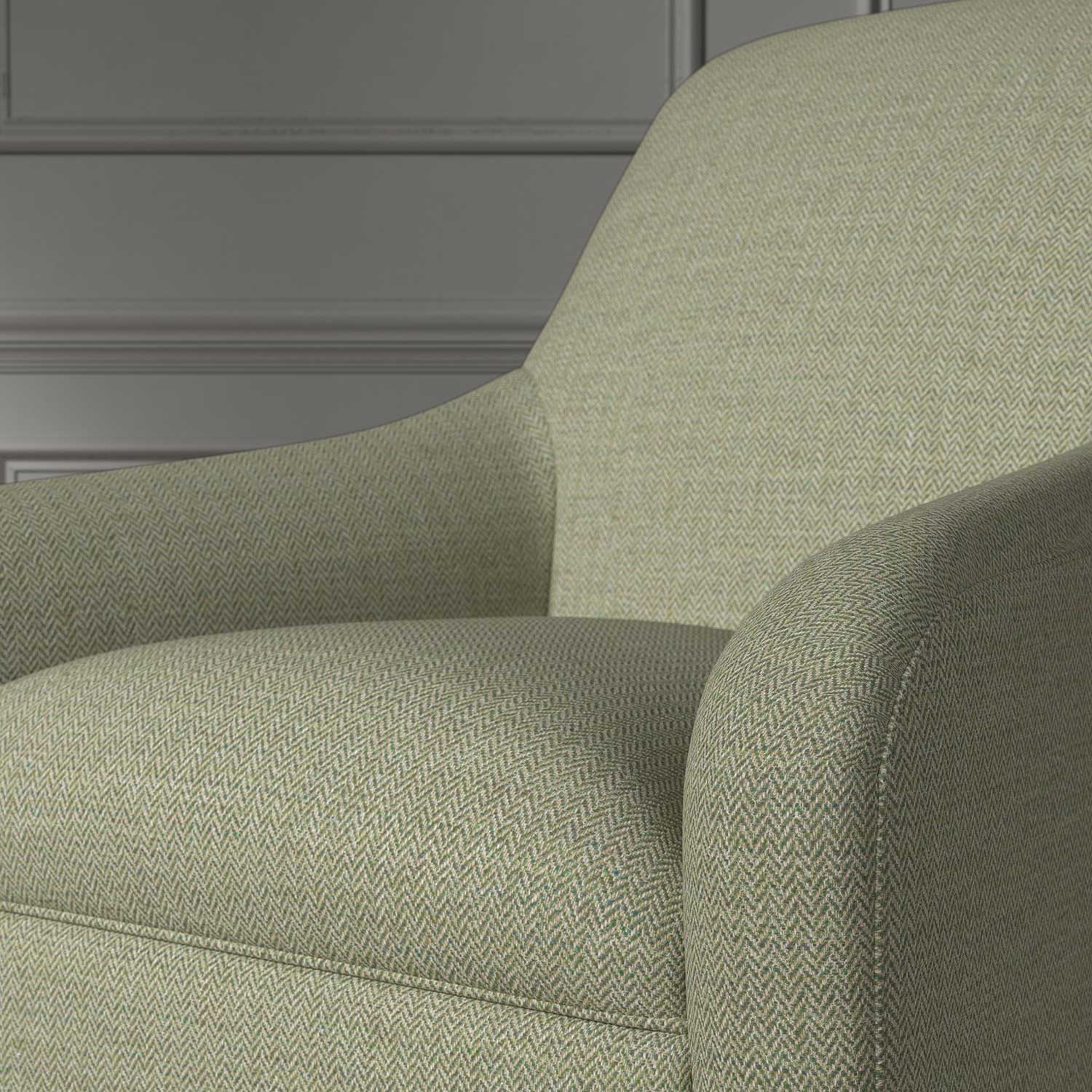 Close up of a chair covered in a woven fabric in a herringbone design in Fern