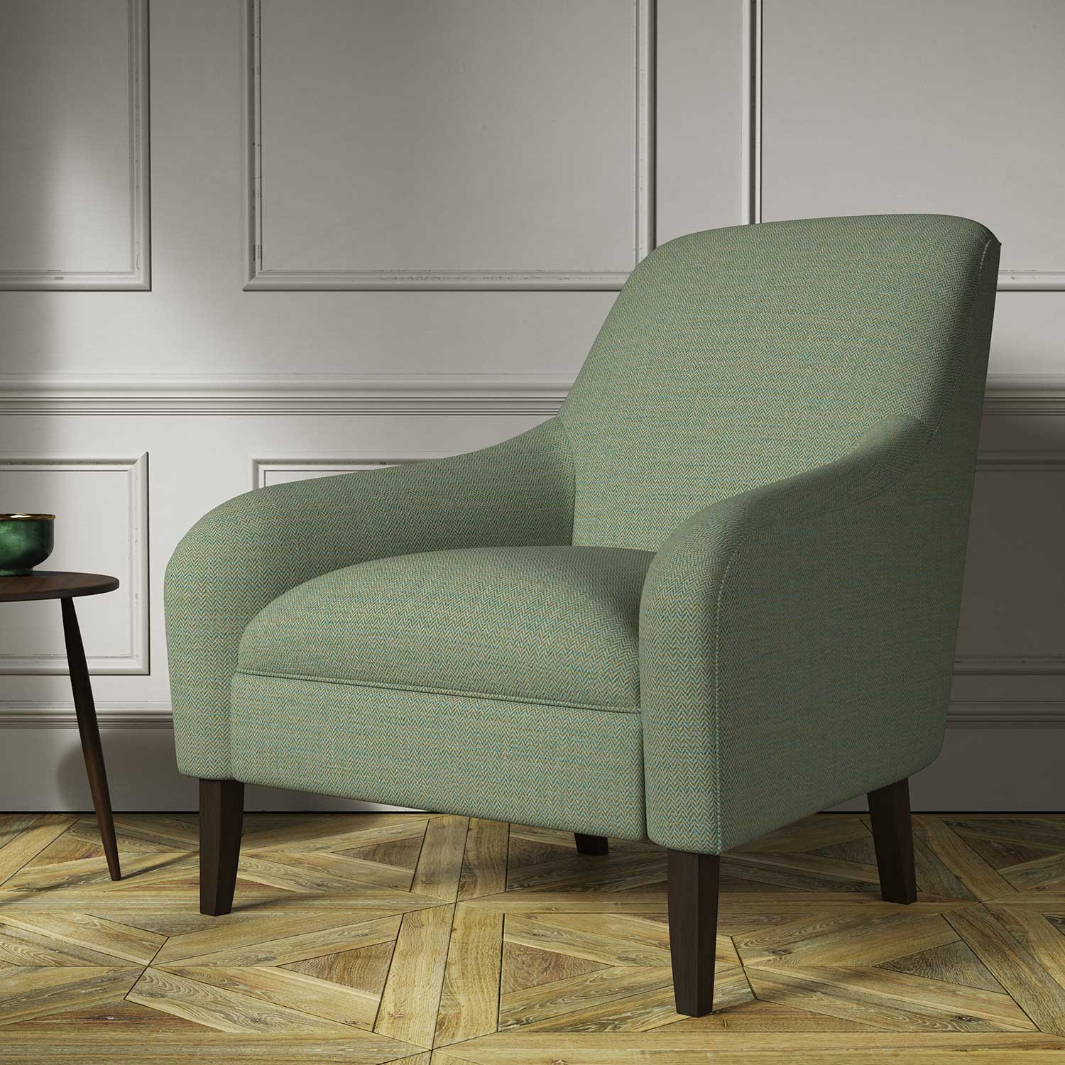 Chair covered in a woven fabric in a herringbone design in Seagrass