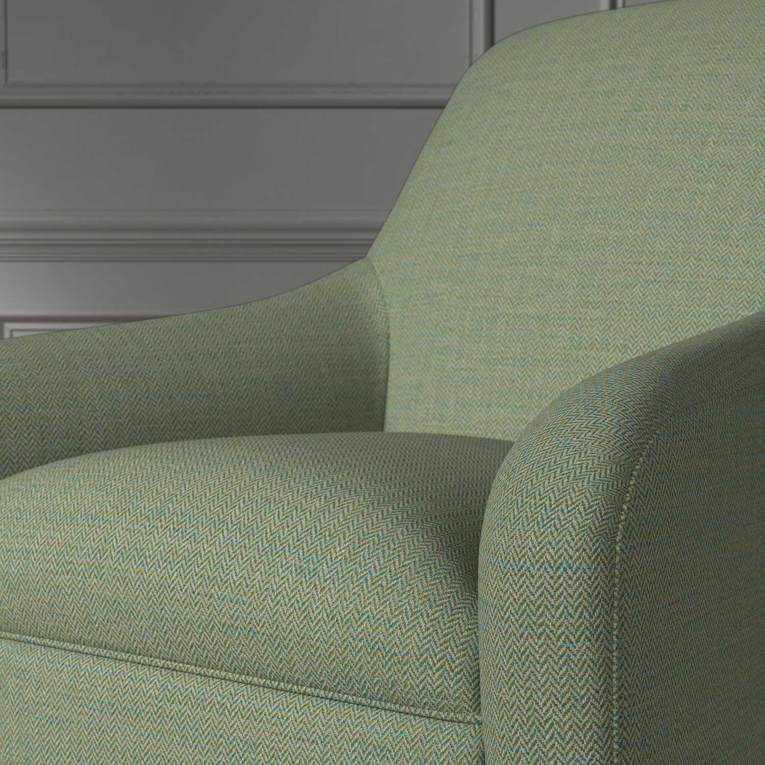 Close up of a chair covered in a woven fabric in a herringbone design in Seagrass