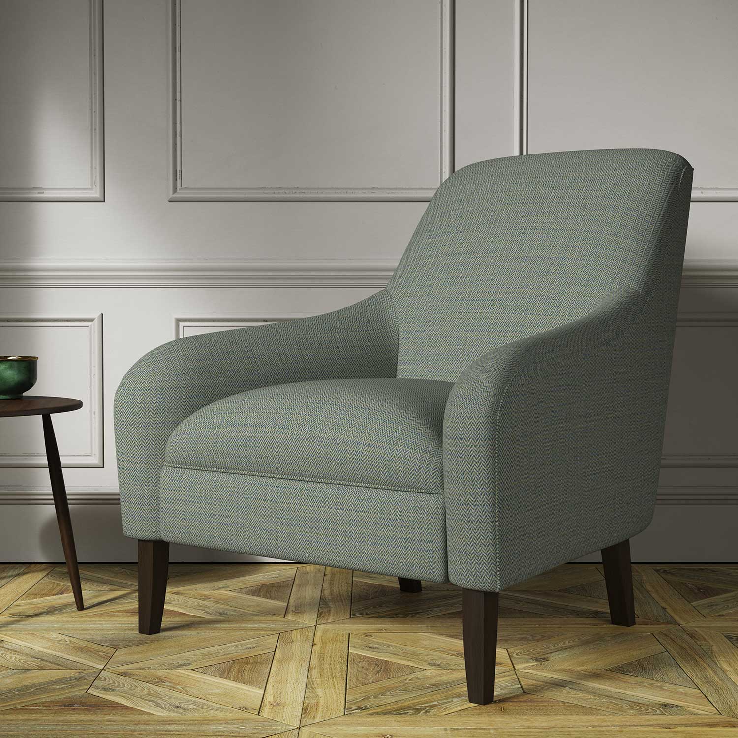 Chair covered in a woven fabric in a herringbone design in Neptune
