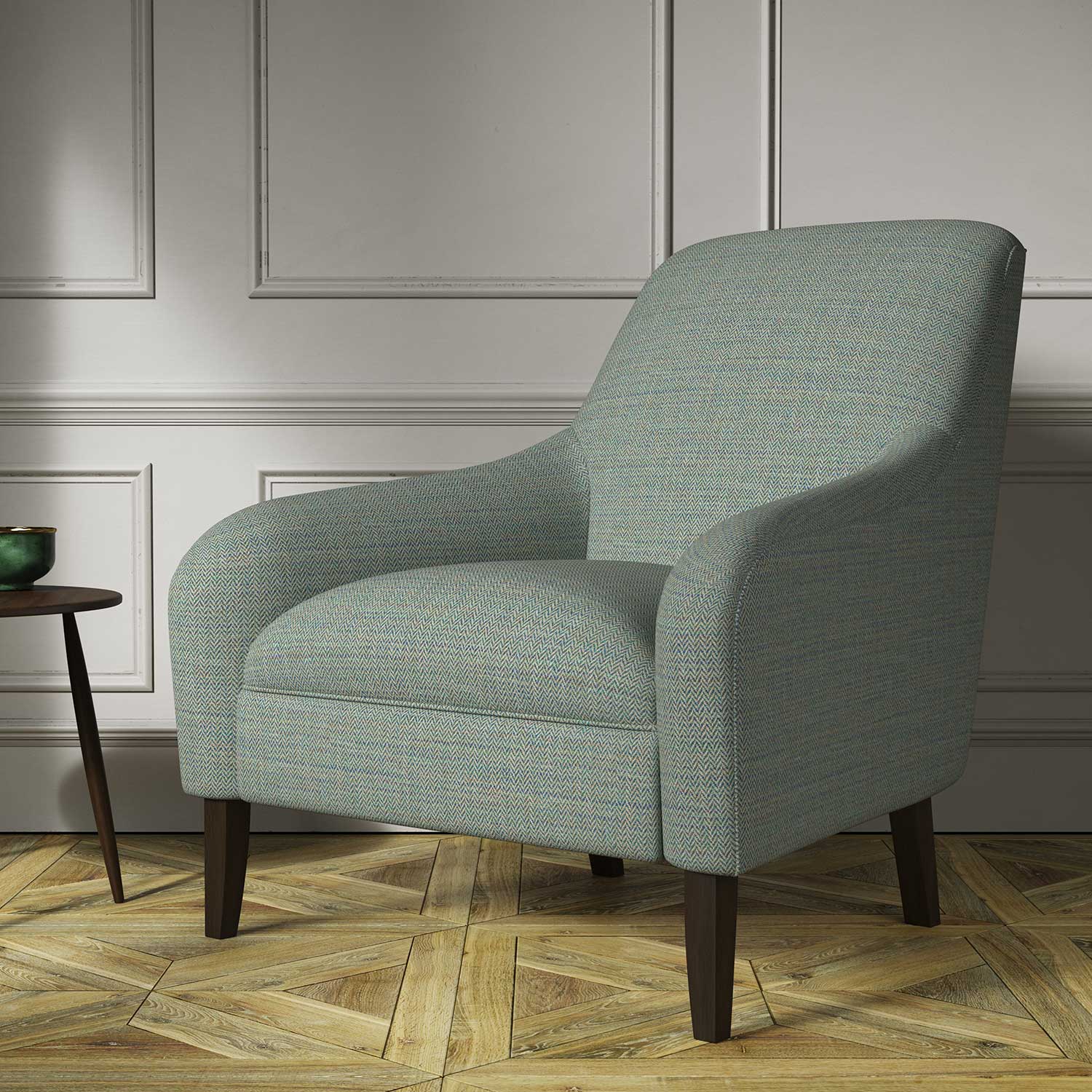 Chair covered in a woven fabric in a herringbone design in Kingfisher