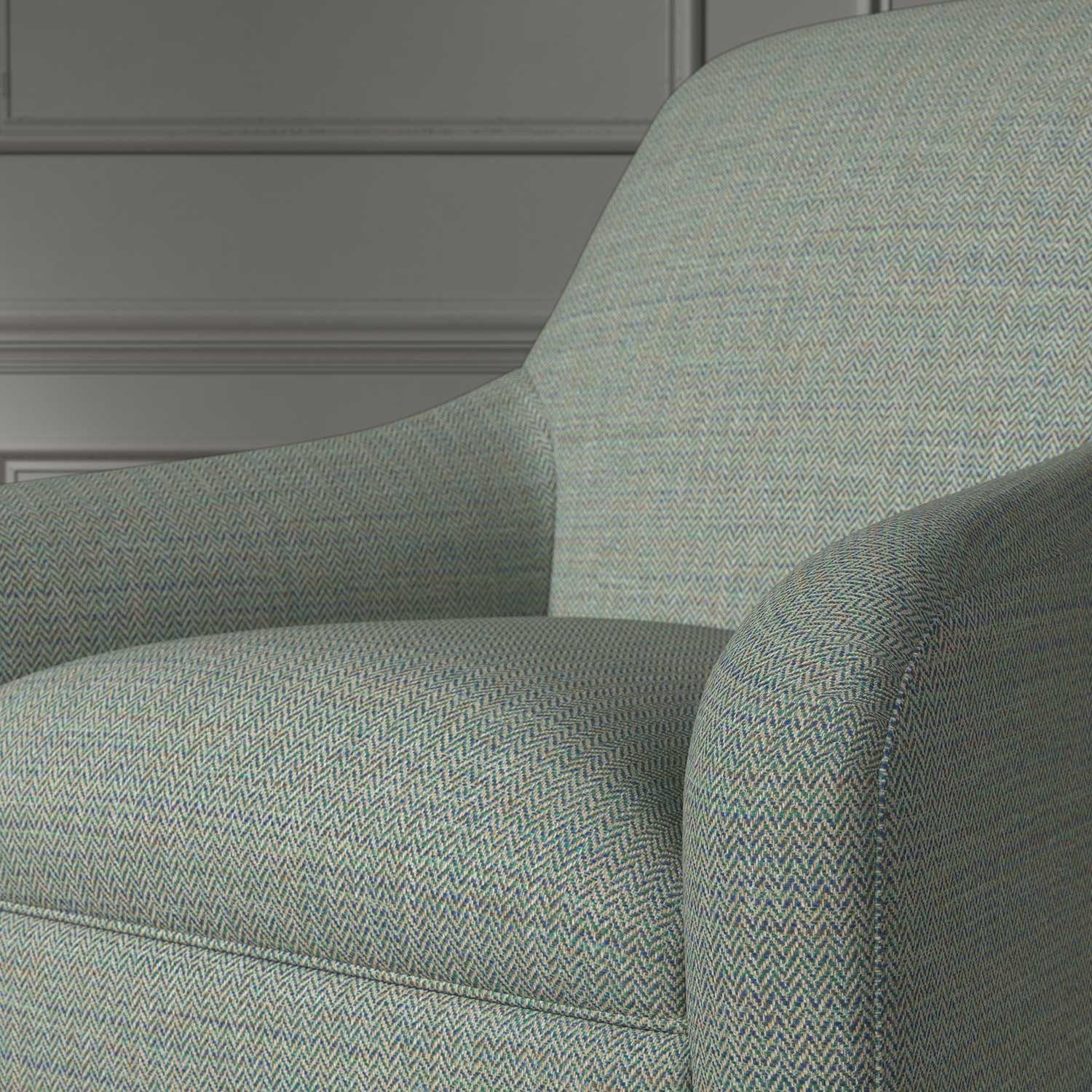 Close up of a chair covered in a woven fabric in a herringbone design in Kingfisher