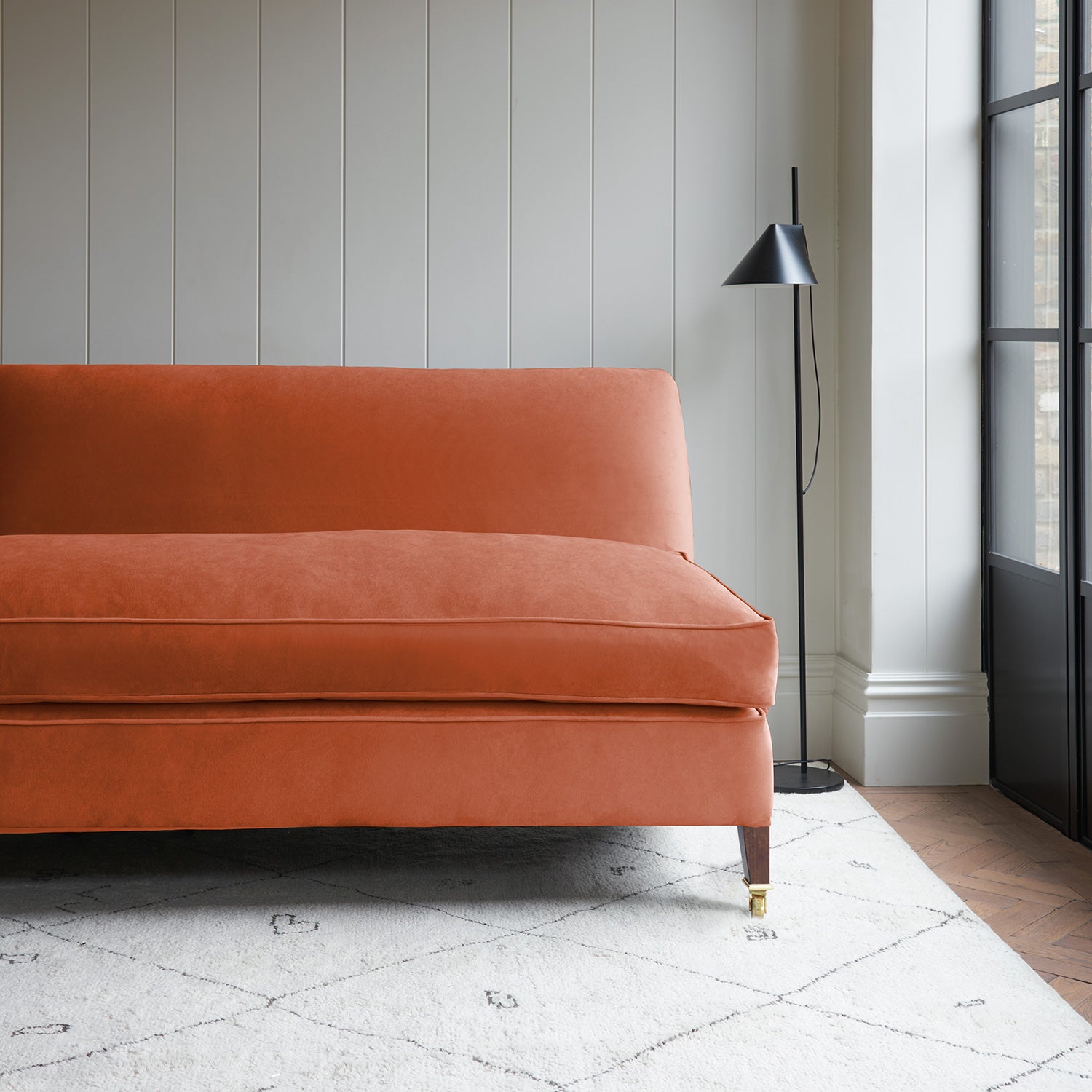 Orange velvet upholstery fabric on a classic sofa.