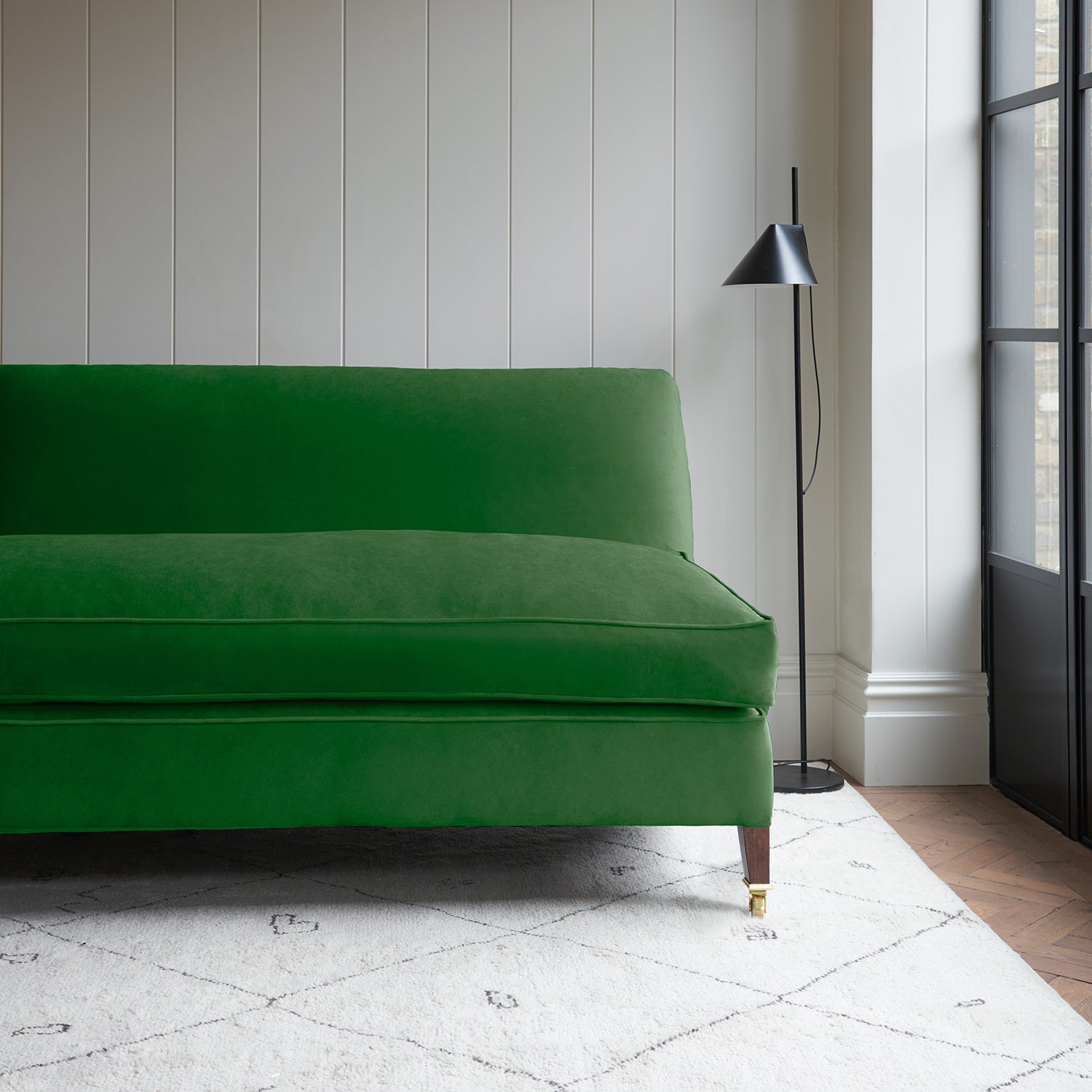Green velvet upholstery fabric on a classic sofa.
