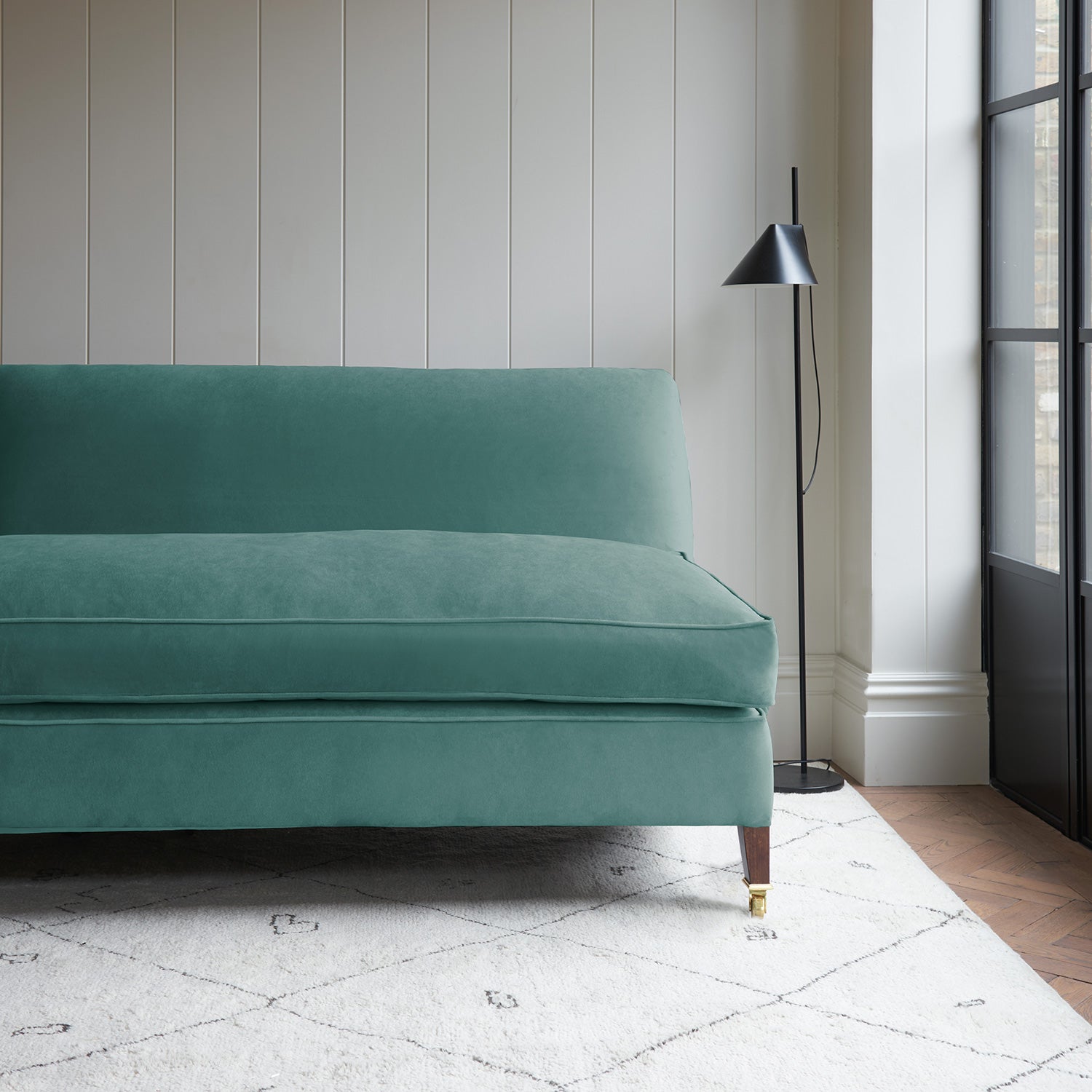 Blue velvet upholstery fabric on a classic sofa.