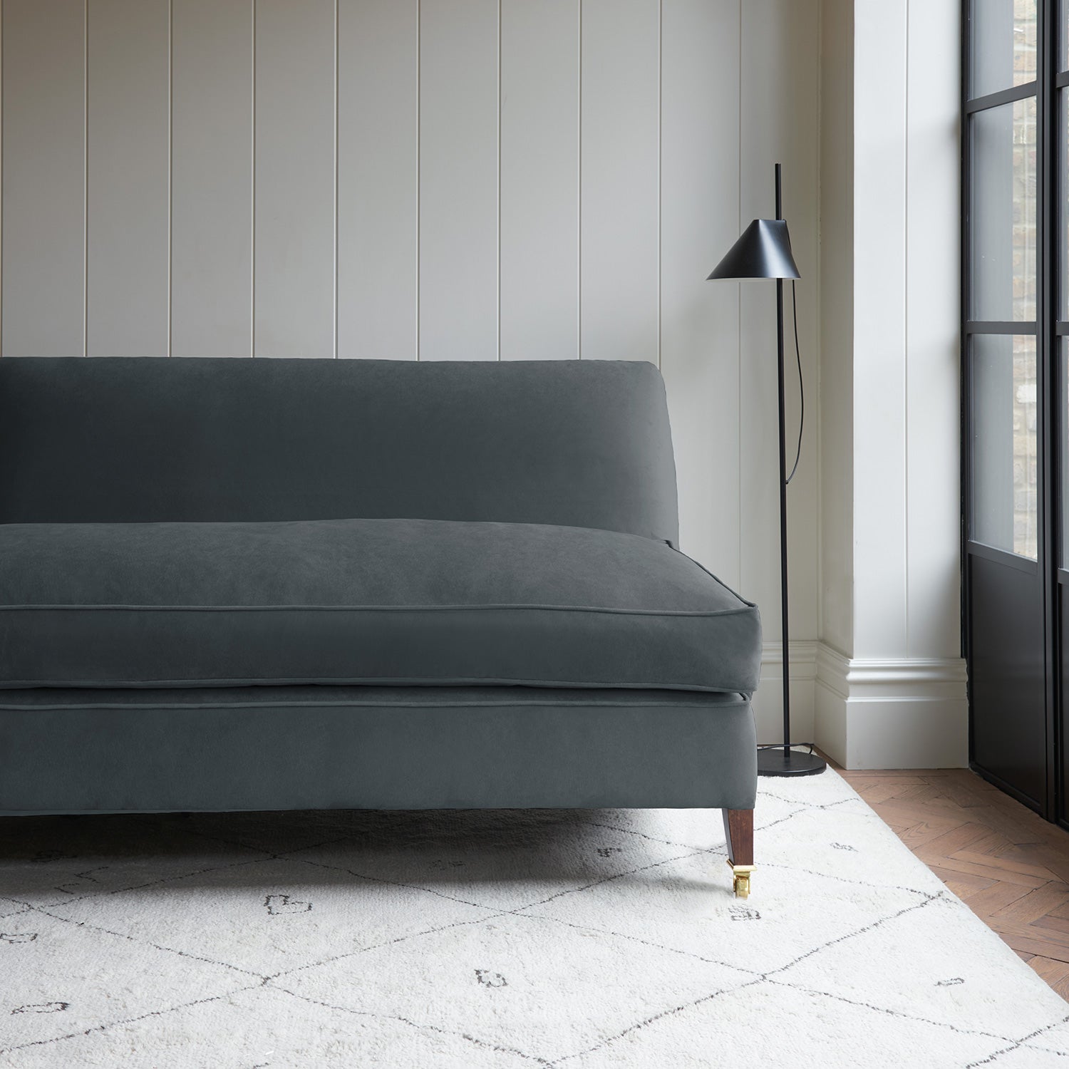 Grey velvet upholstery fabric on a classic sofa.