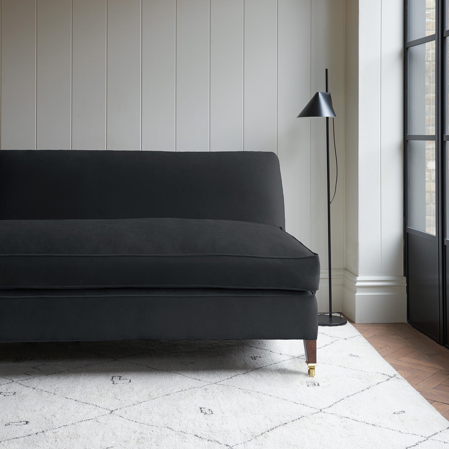 Black velvet upholstery fabric on a classic sofa.