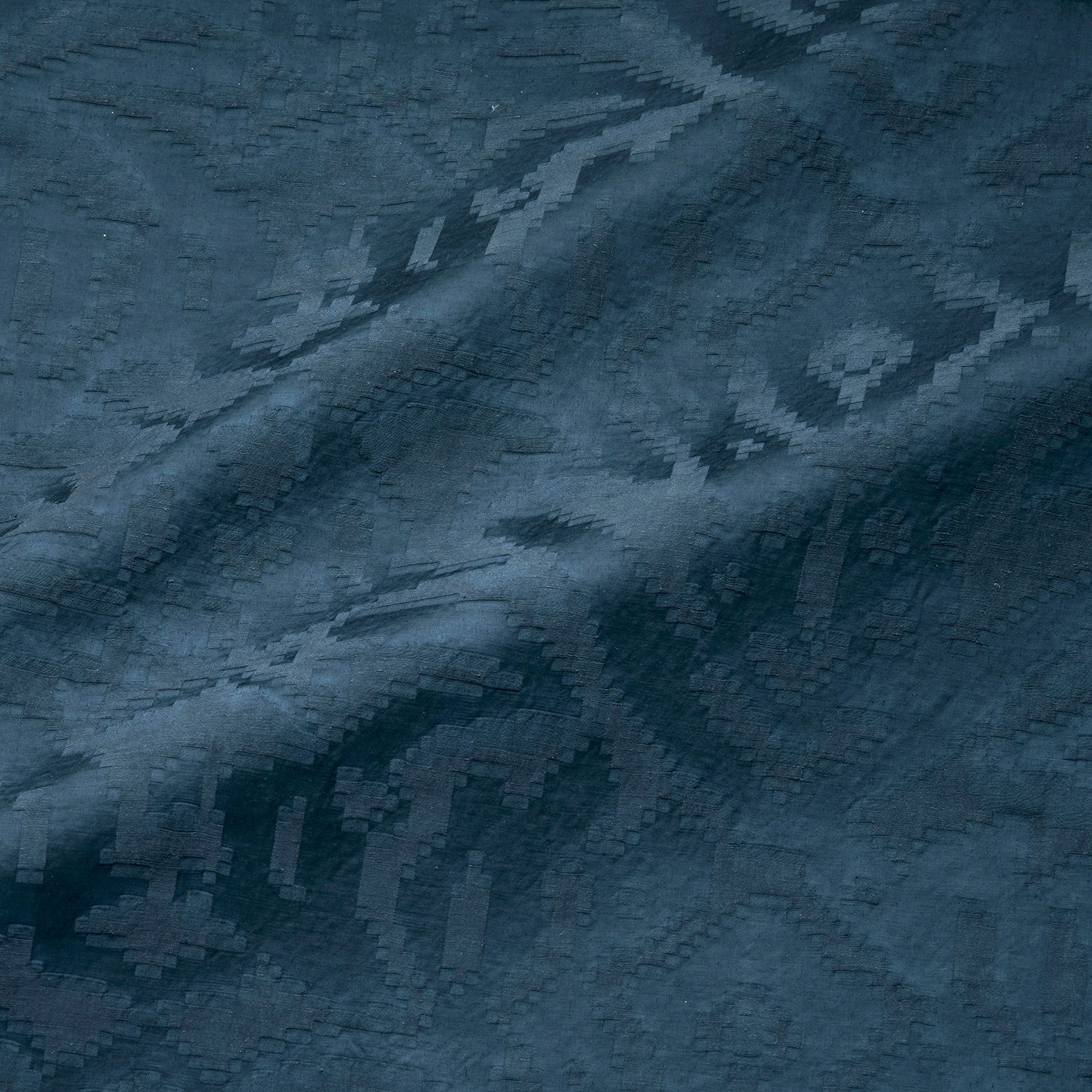 Fabric swatch of a dark blue, soft fabric with jacquard design for curtain use