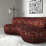 Sofa in printed velvet fabric – an exuberant carpet design in red colours.