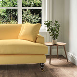 A yellow stain resistant woven fabric on an armchair