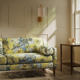 Sofa upholstered in a linen fabric with a floral and bird design