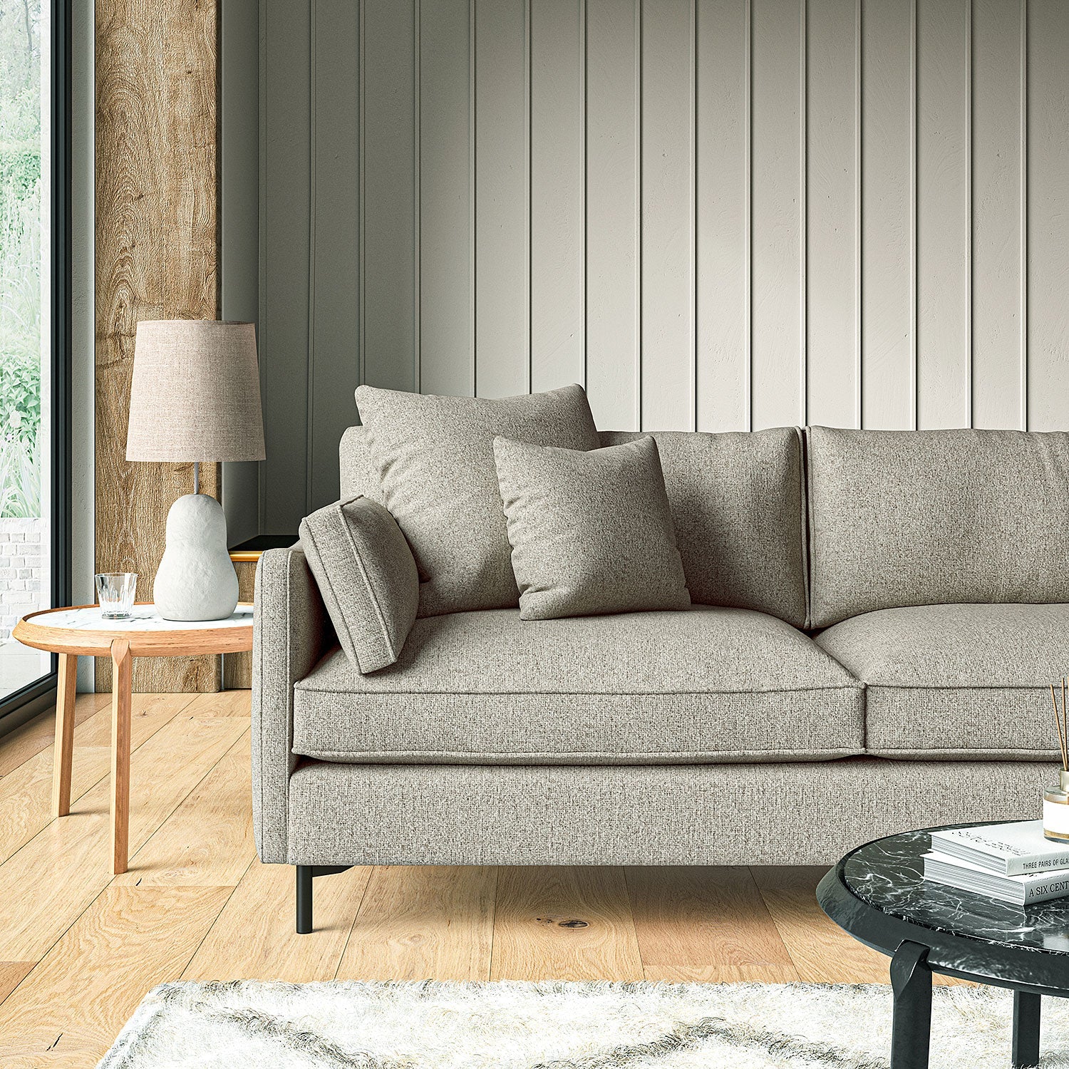 Sofa covered in a boucle fabric in Aluminium