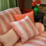 Printed linen fabric - fresh bands of jolly colours in pink, red, yellow and cream – on a sofa