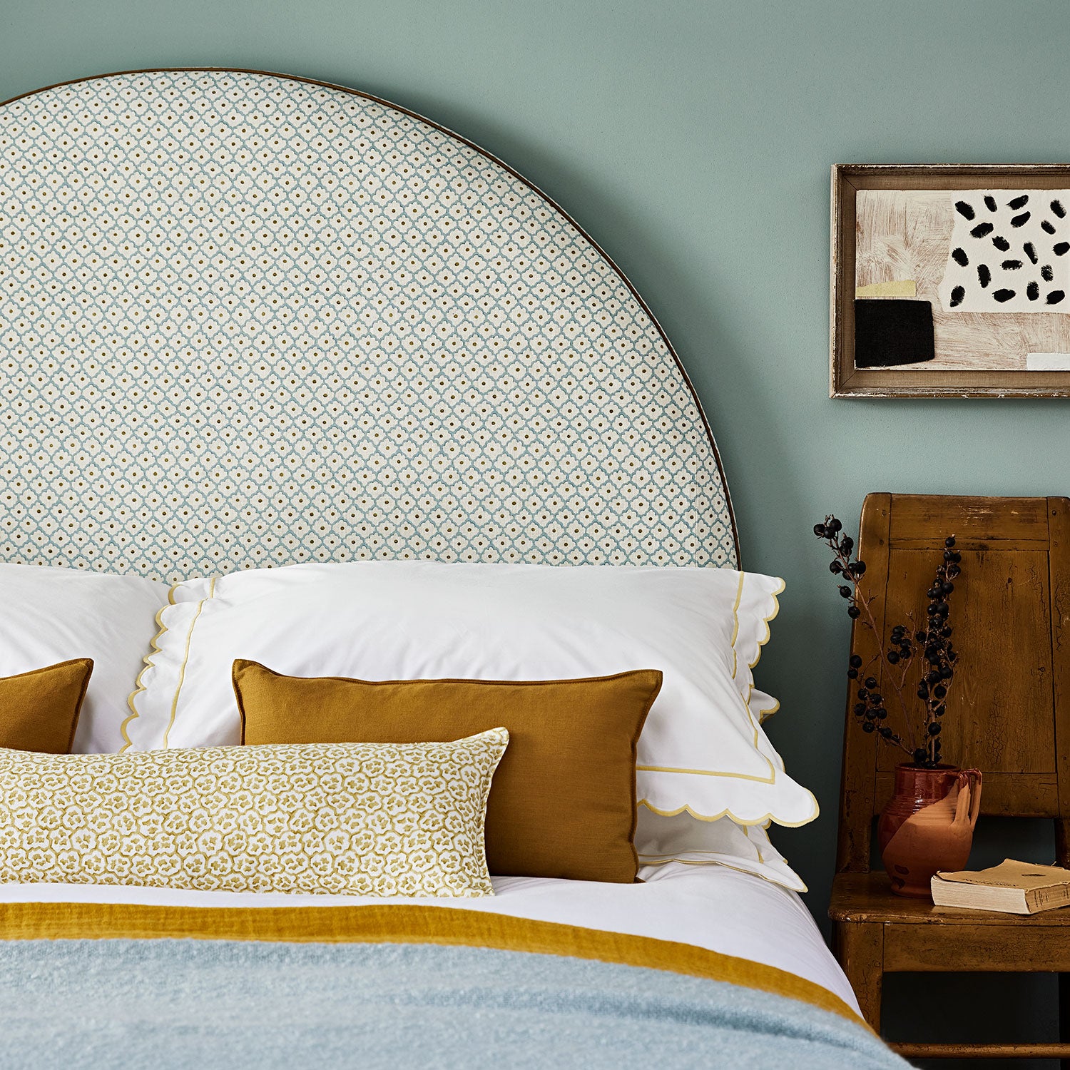 Printed linen fabric – a classic trellis design in blue, yellow, and cream – on a headboard