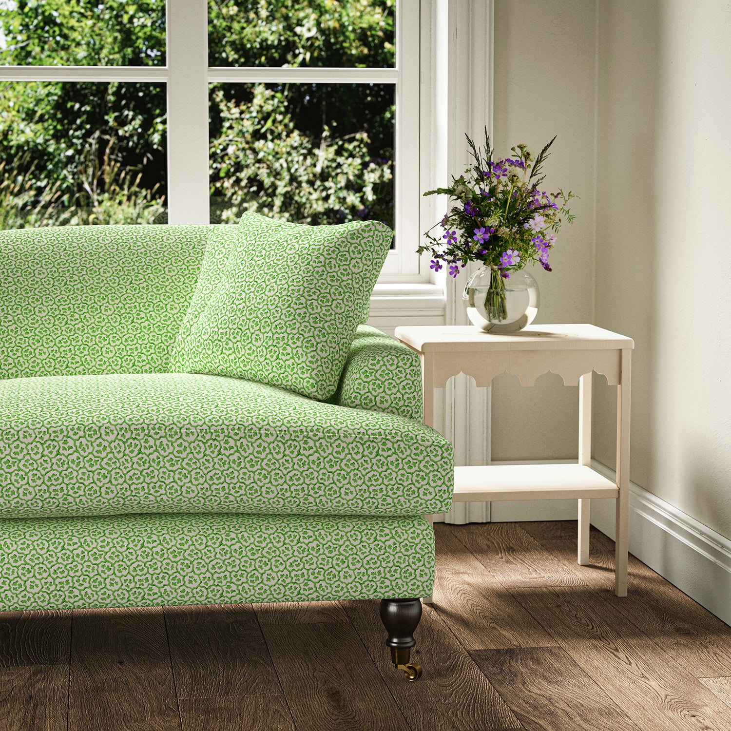 Printed linen fabric – a handy block print pattern in green and cream – on a sofa