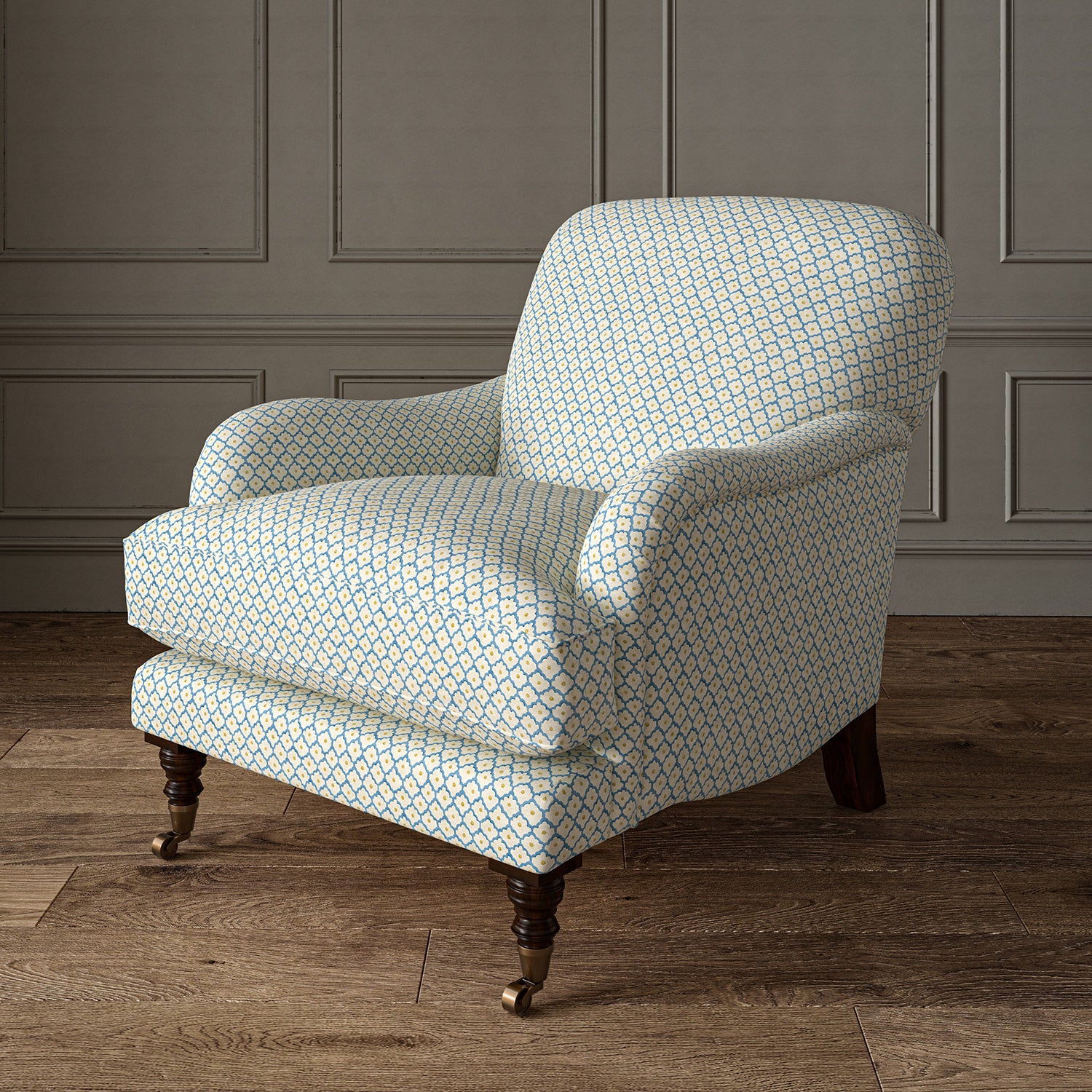 Printed linen fabric – a classic trellis design in blue, yellow, and cream – on an armchair.
