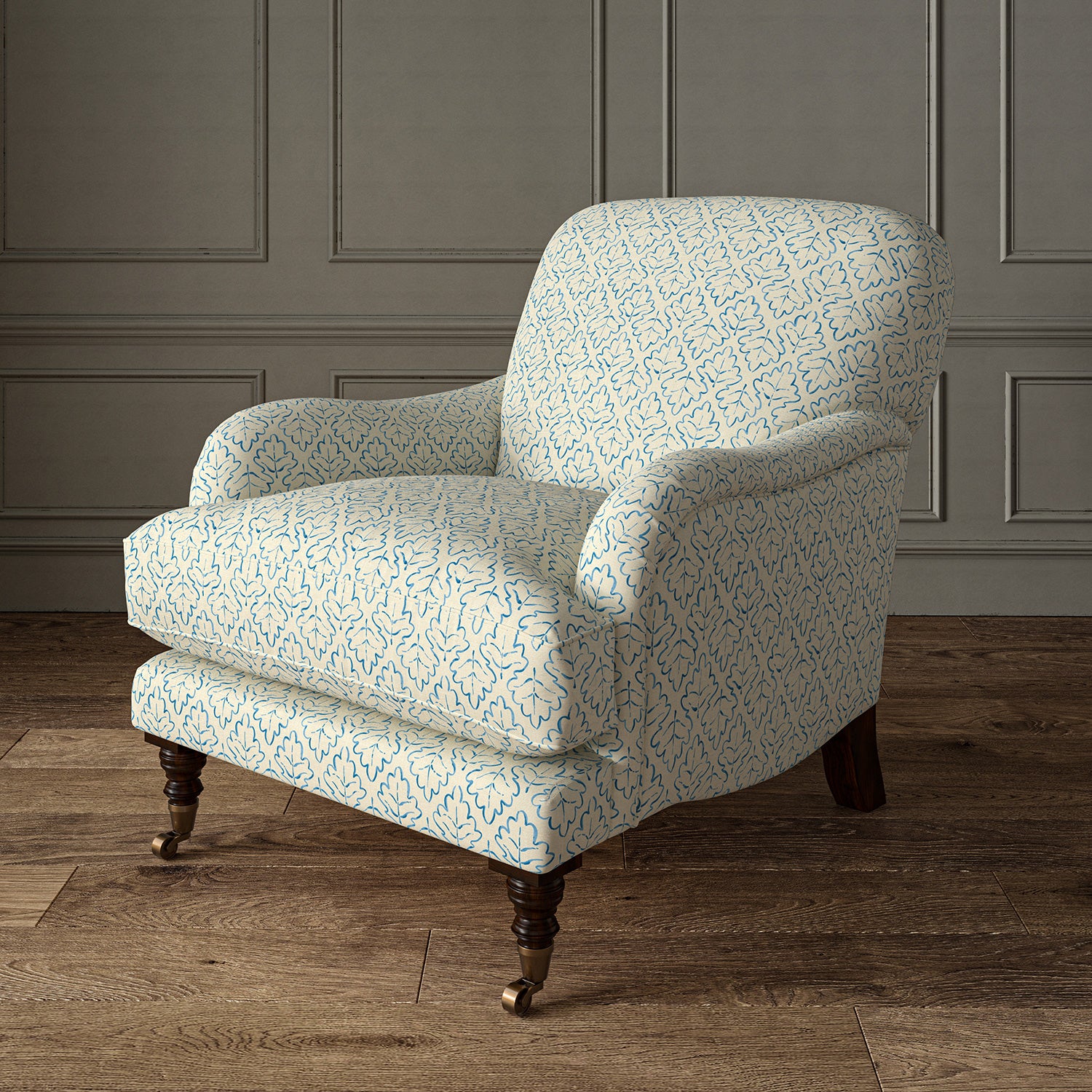 Printed linen fabric – a hand drawn; mirrored leaf motif pattern in blue and cream – on an armchair