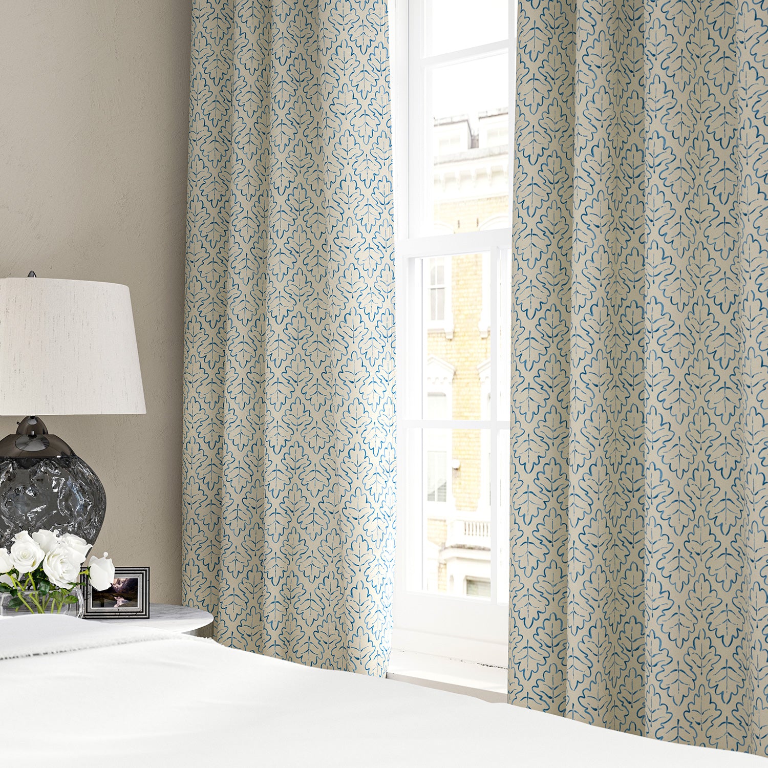 Linen curtains with a hand drawn; mirrored leaf motif pattern in blue and cream